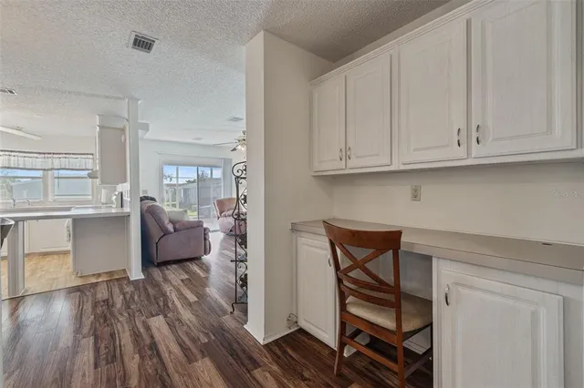 a kitchen with cabinets table and chairs