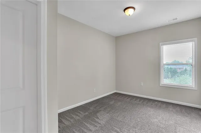 a view of a livingroom with an empty space and window