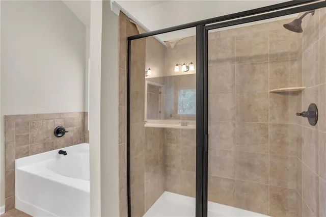 a bathroom with a bathtub and shower