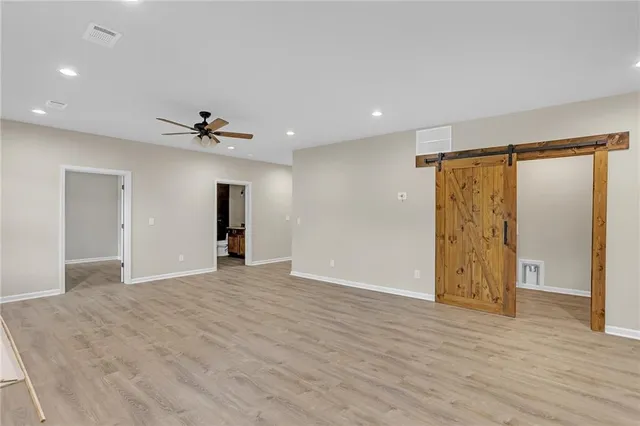 a view of an empty room with wooden floor