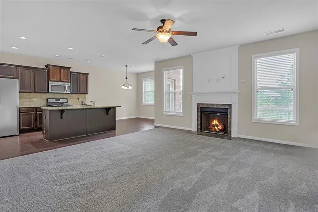 a view of kitchen with a stove cabinets and a fireplace
