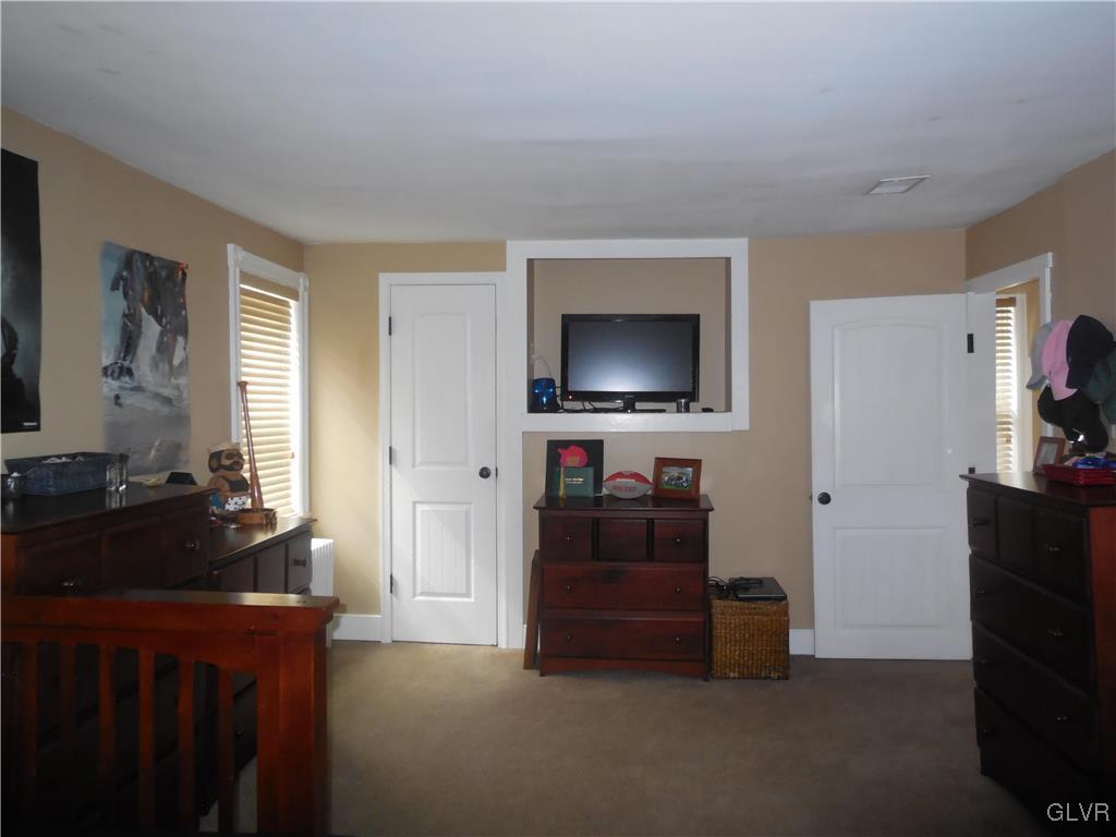 1425 North Brookside Road Lower Macungie Township, PA 18106 - Photo 17 of 31 a living room with furniture and a flat screen tv