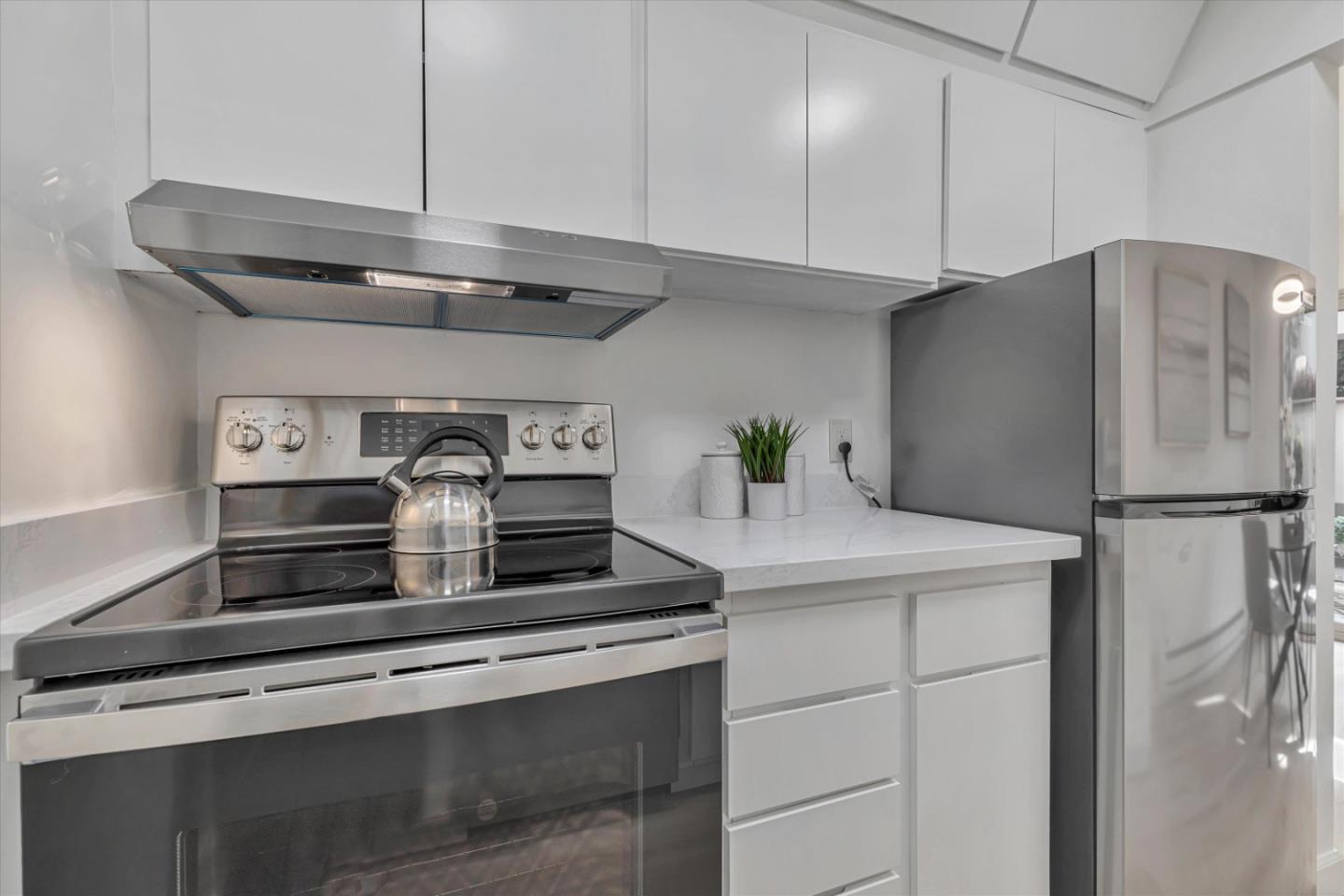 500 West Middlefield Road, Unit 142 Mountain View, CA 94043 - Photo 20 of 59 a kitchen with stainless steel appliances a refrigerator and cabinets