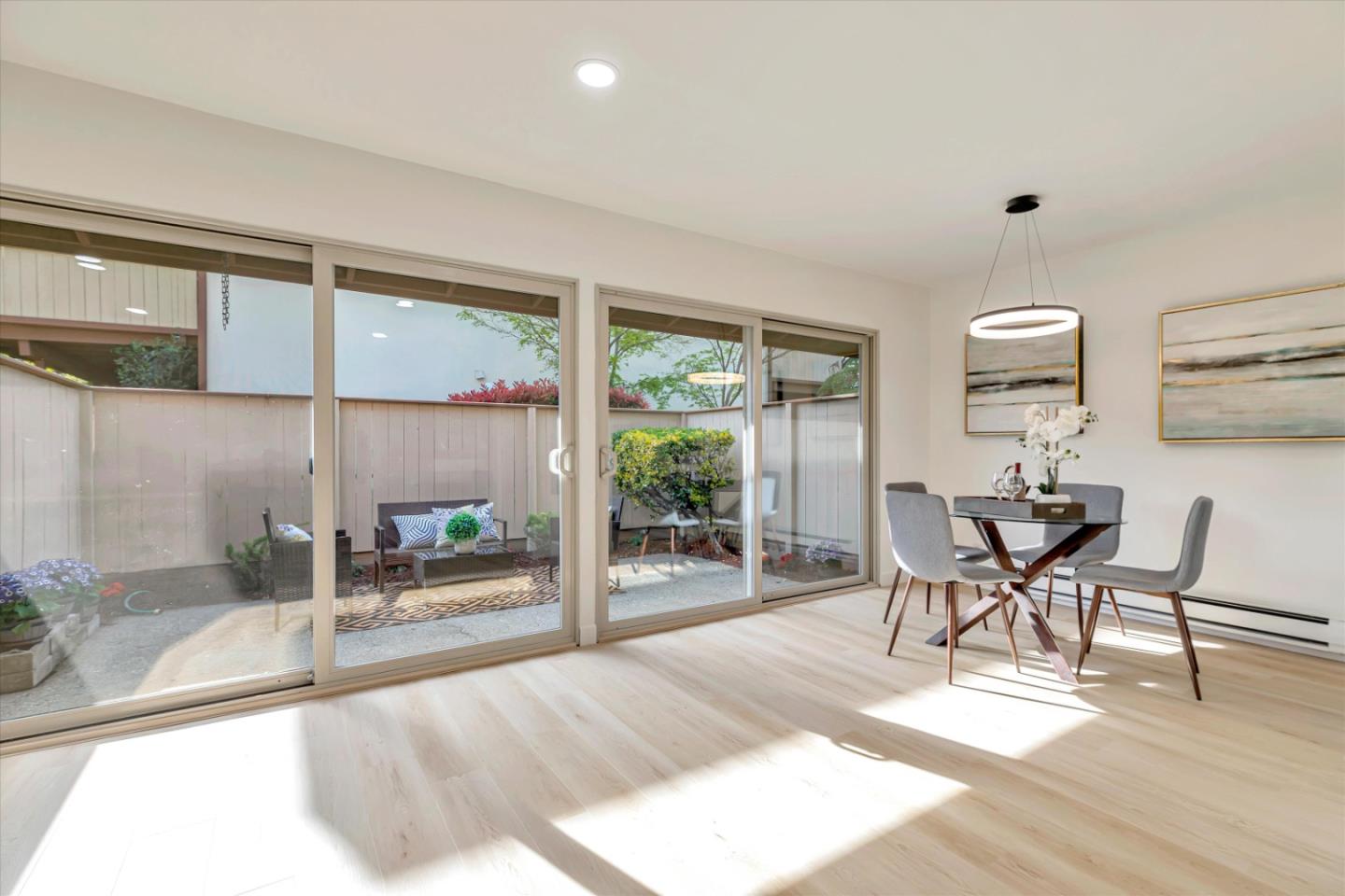 500 West Middlefield Road, Unit 142 Mountain View, CA 94043 - Photo 24 of 59 a dining room with wooden floor and a floor to ceiling window