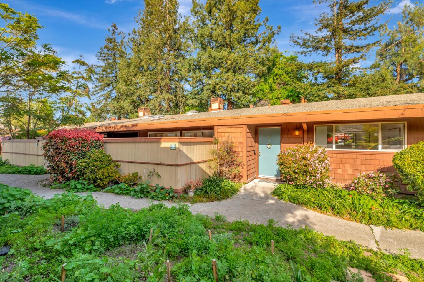 500 West Middlefield Road, Unit 142 Mountain View, CA 94043 - Photo 4 of 59 a view of a backyard with potted plants and large tree