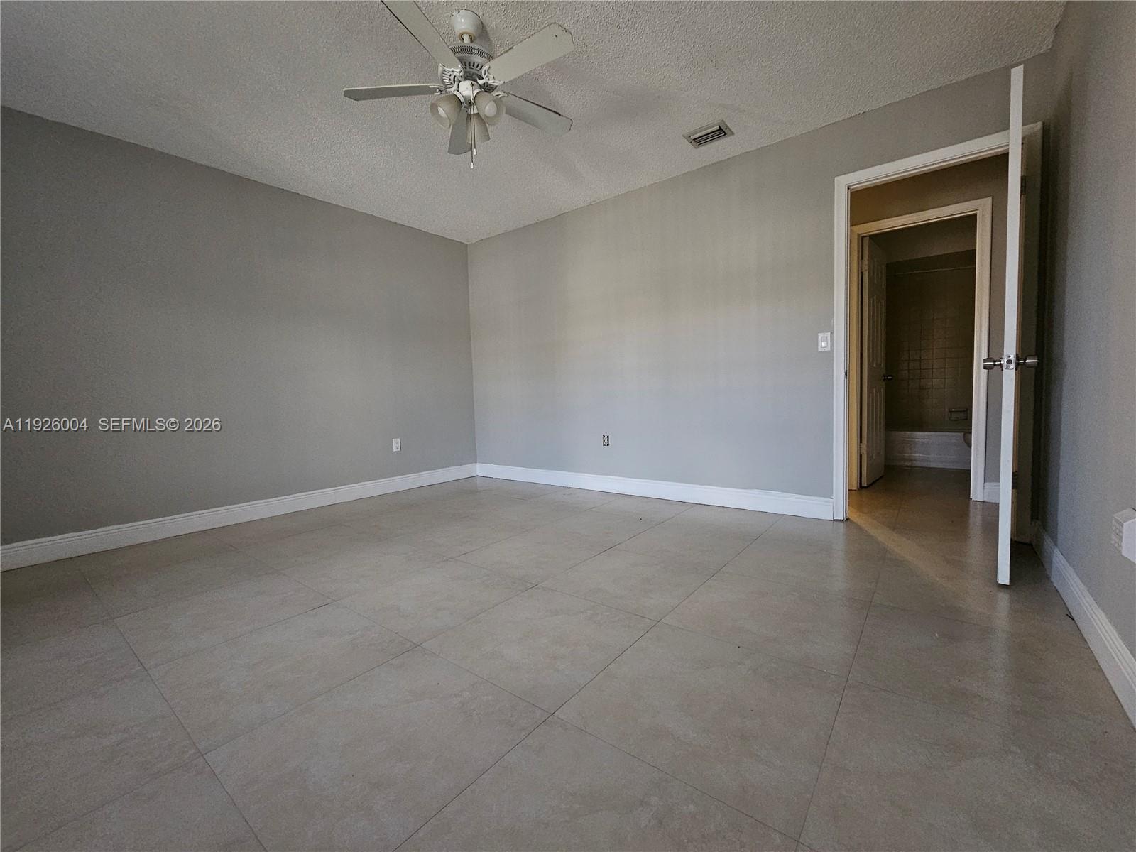 5317 Southwest 140th Place, Unit 5317 Miami, FL 33175 - Photo 13 of 30 an empty room with a ceiling fan and a window