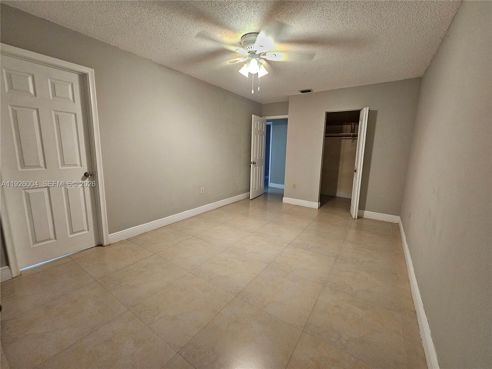 5317 Southwest 140th Place, Unit 5317 Miami, FL 33175 - Photo 15 of 30 an empty room with closet and a ceiling fan