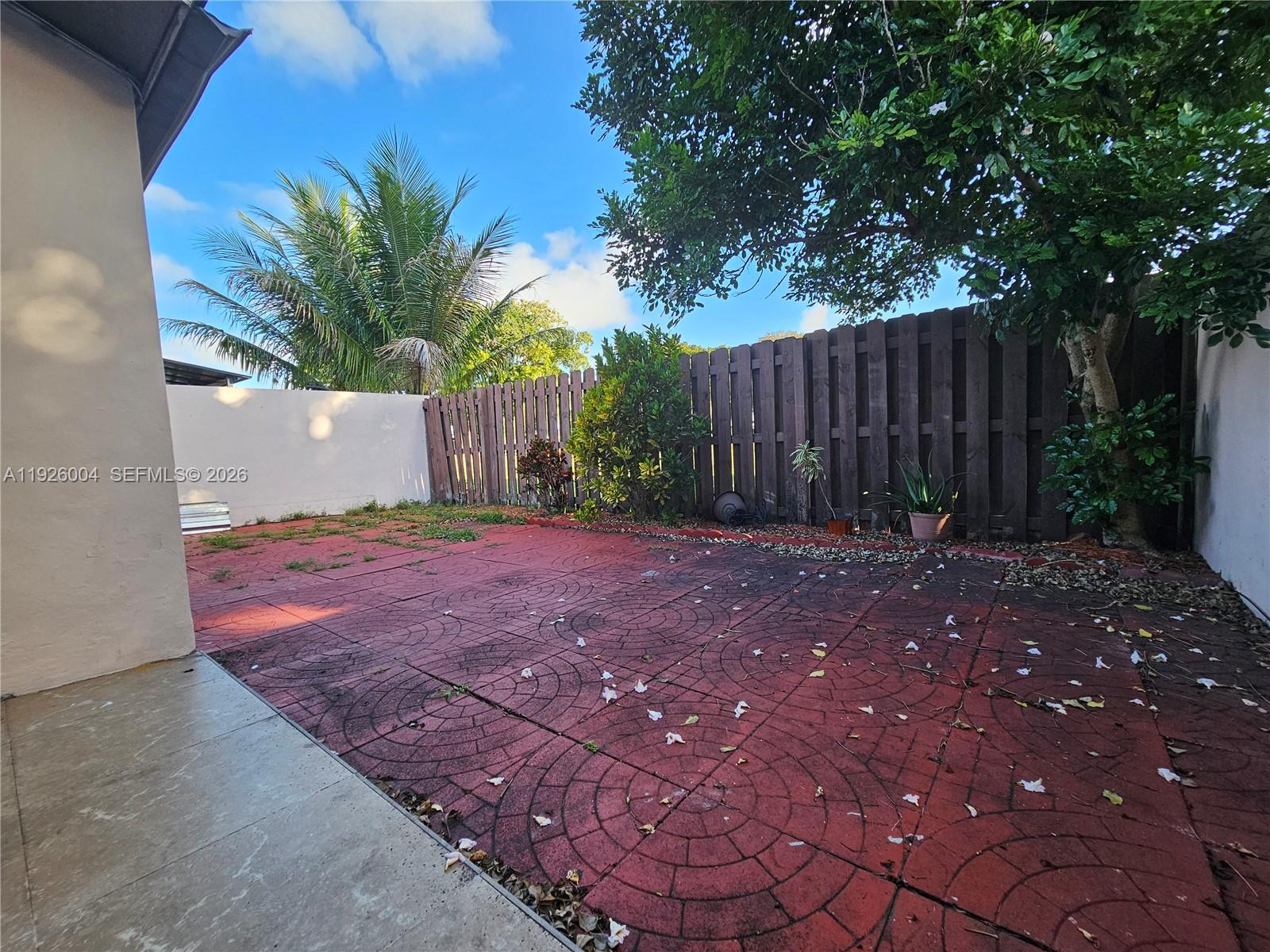 5317 Southwest 140th Place, Unit 5317 Miami, FL 33175 - Photo 17 of 30 a view of backyard with potted plants and wooden fence