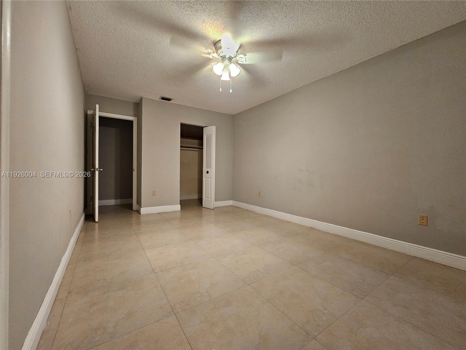5317 Southwest 140th Place, Unit 5317 Miami, FL 33175 - Photo 20 of 30 a view of an empty room with a ceiling fan