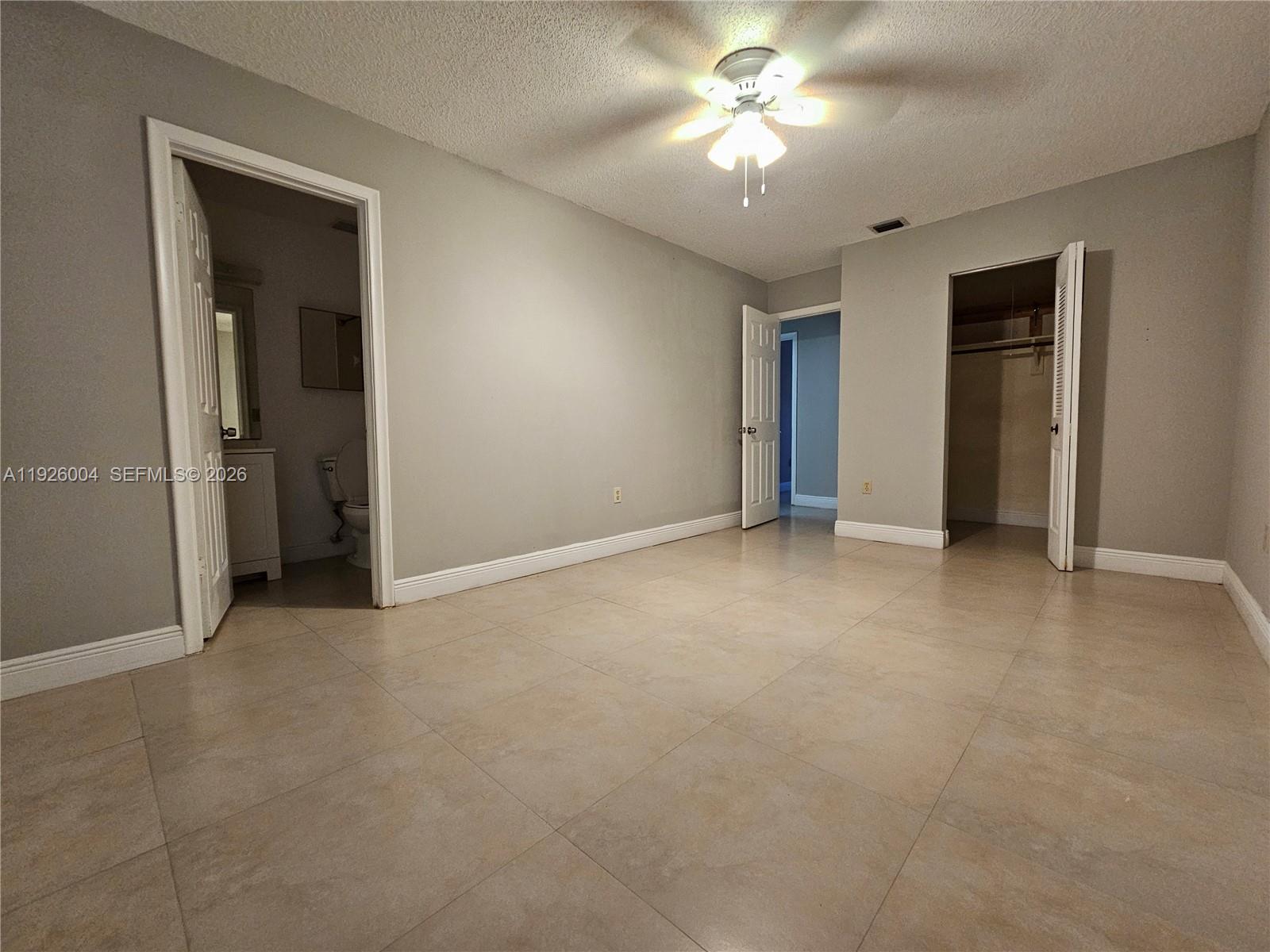 5317 Southwest 140th Place, Unit 5317 Miami, FL 33175 - Photo 21 of 30 a view of an empty room with a chandelier fan