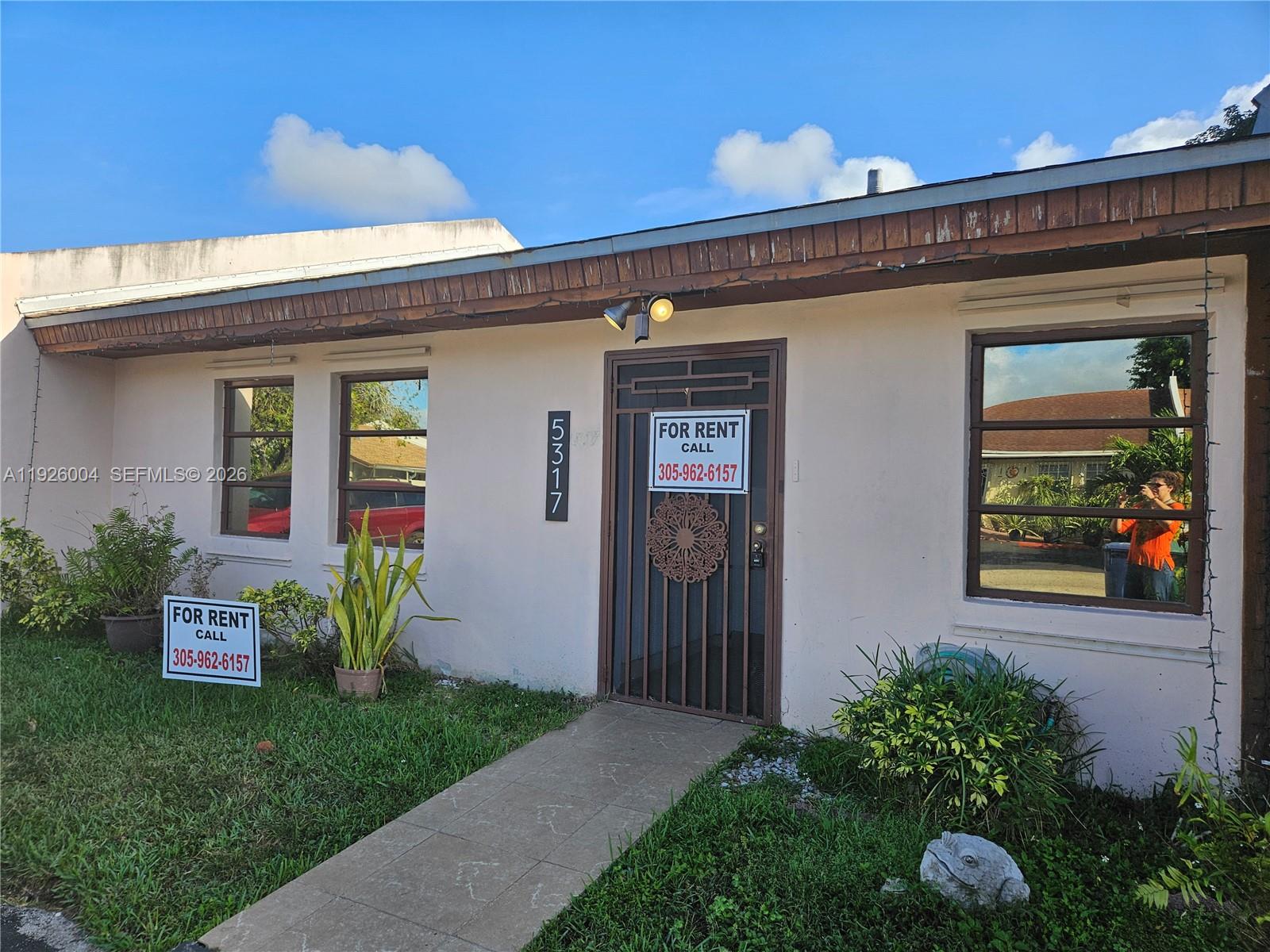5317 Southwest 140th Place, Unit 5317 Miami, FL 33175 - Photo 27 of 30 a front view of a house with garden