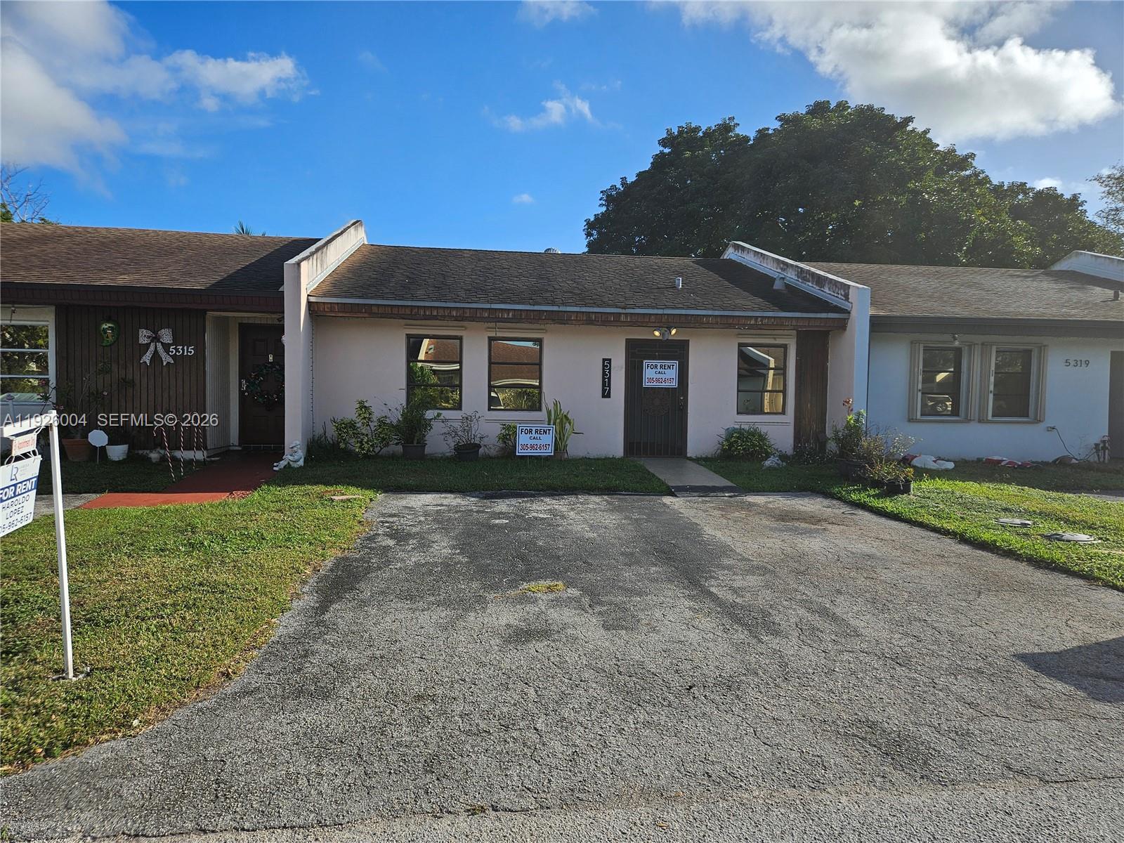 5317 Southwest 140th Place, Unit 5317 Miami, FL 33175 - Photo 28 of 30 a front view of house with yard and green space