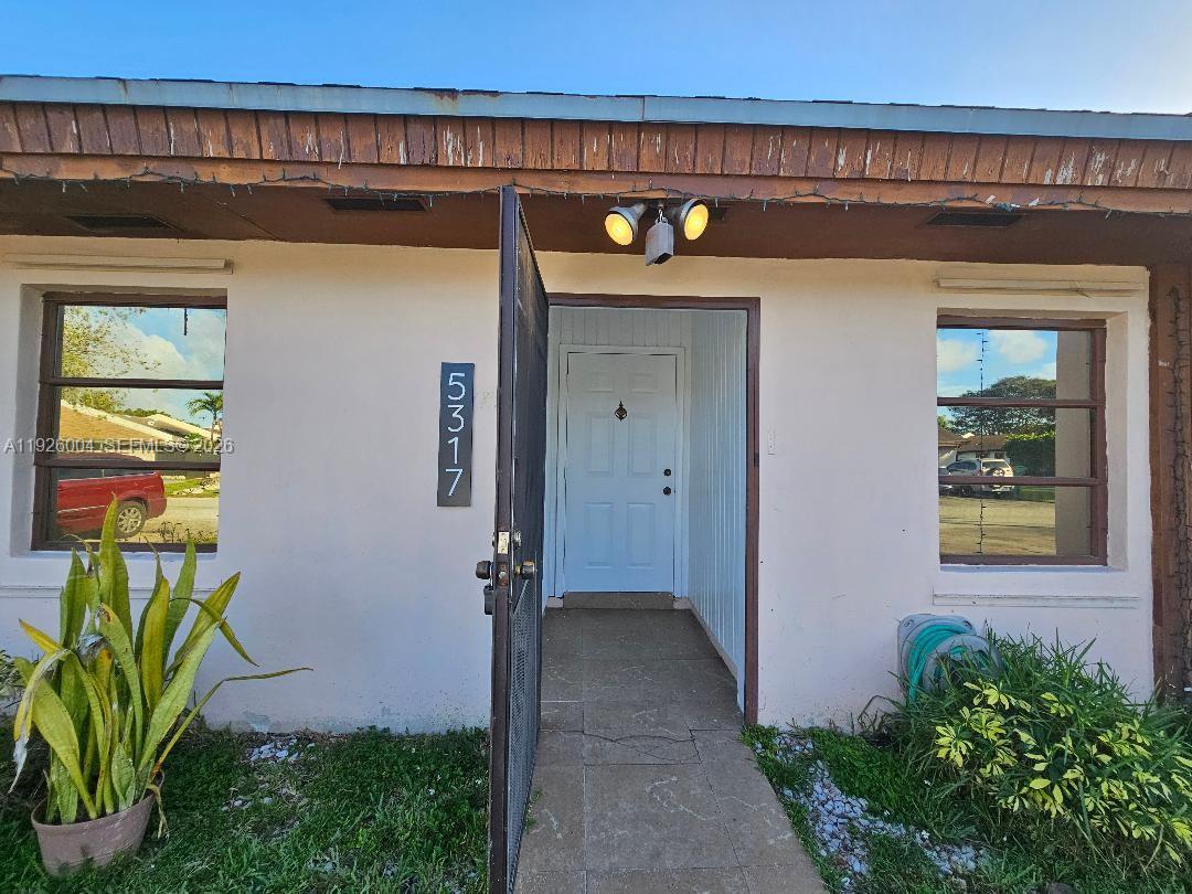 5317 Southwest 140th Place, Unit 5317 Miami, FL 33175 - Photo 30 of 30 a front view of a house with garden