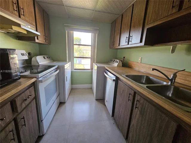 a kitchen with stainless steel appliances granite countertop a sink and a stove