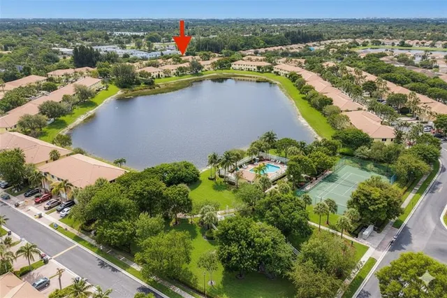 an aerial view of residential houses with outdoor space and river