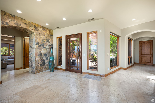 2331 West Entrada Trail, Unit 61 St. George, UT 84770 - Photo 8 of 69 Spacious foyer featuring stone-clad walls, arched doorways, recessed lighting, and large format tile flooring