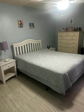 a bedroom with a bed and a dresser
