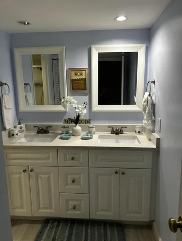 a bathroom with a double vanity sink and mirror
