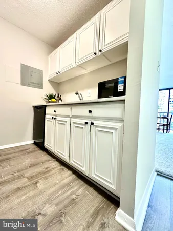 a kitchen with stainless steel appliances granite countertop a sink and dishwasher with white cabinets