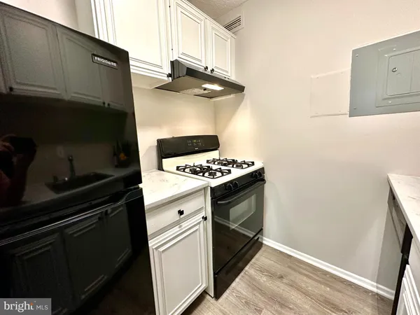 a kitchen with granite countertop a stove and a microwave