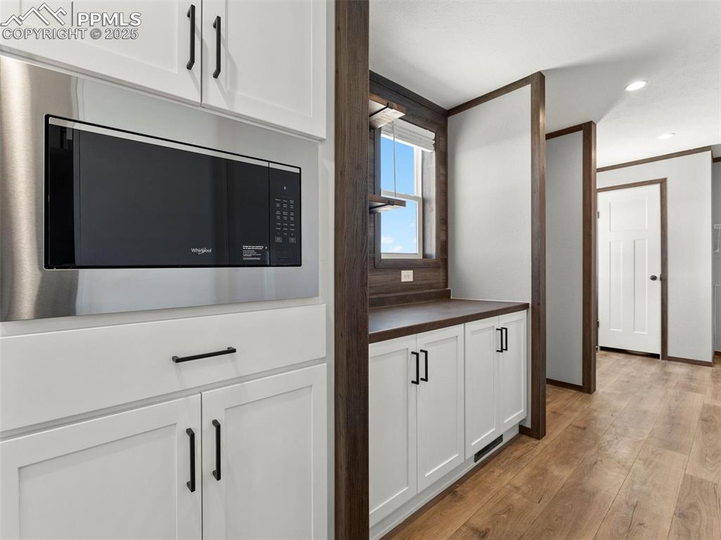 2690 East Ellicott Road South Calhan, CO 80808 - Photo 17 of 46 a kitchen with stainless steel appliances white cabinets and a microwave oven