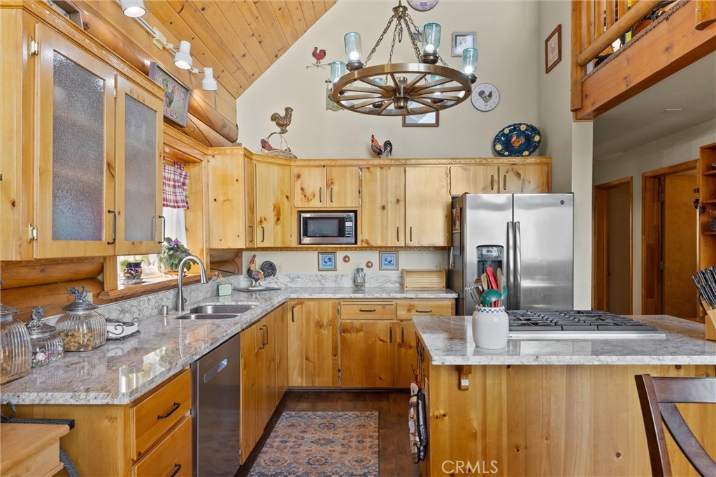 4592 Wendlis Road Forest Ranch, CA 95942 - Photo 12 of 64 a kitchen with kitchen island granite countertop a sink stainless steel appliances cabinets and a counter top space