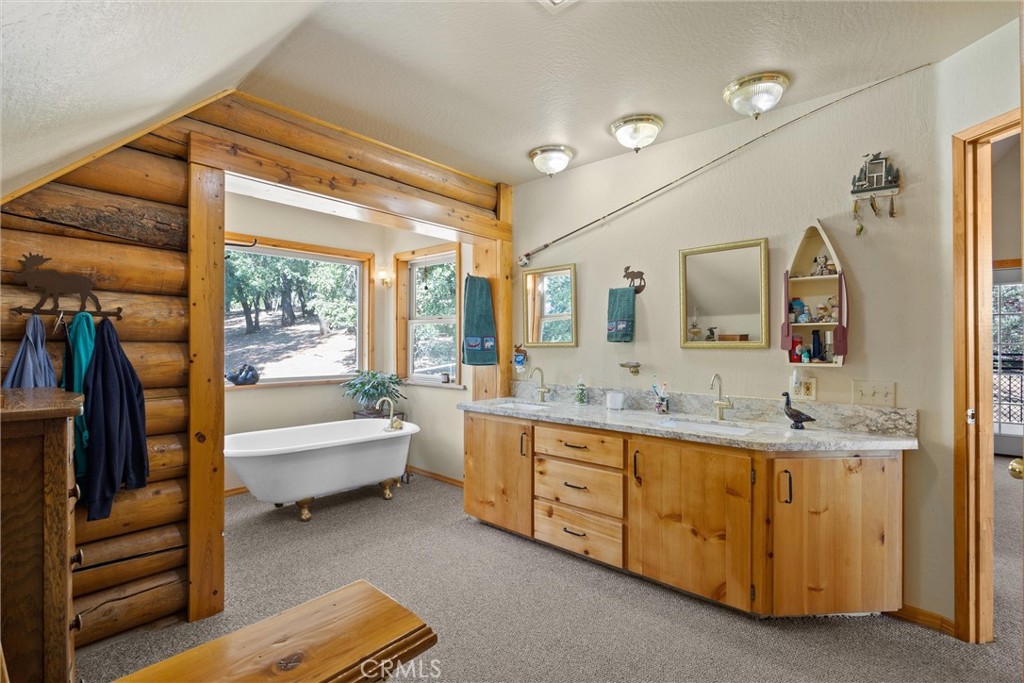 4592 Wendlis Road Forest Ranch, CA 95942 - Photo 30 of 64 a spacious bathroom with a double vanity sink a mirror and a bathtub