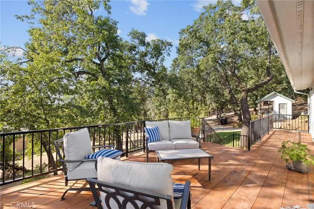 a view of a patio with a table and chairs with wooden fence