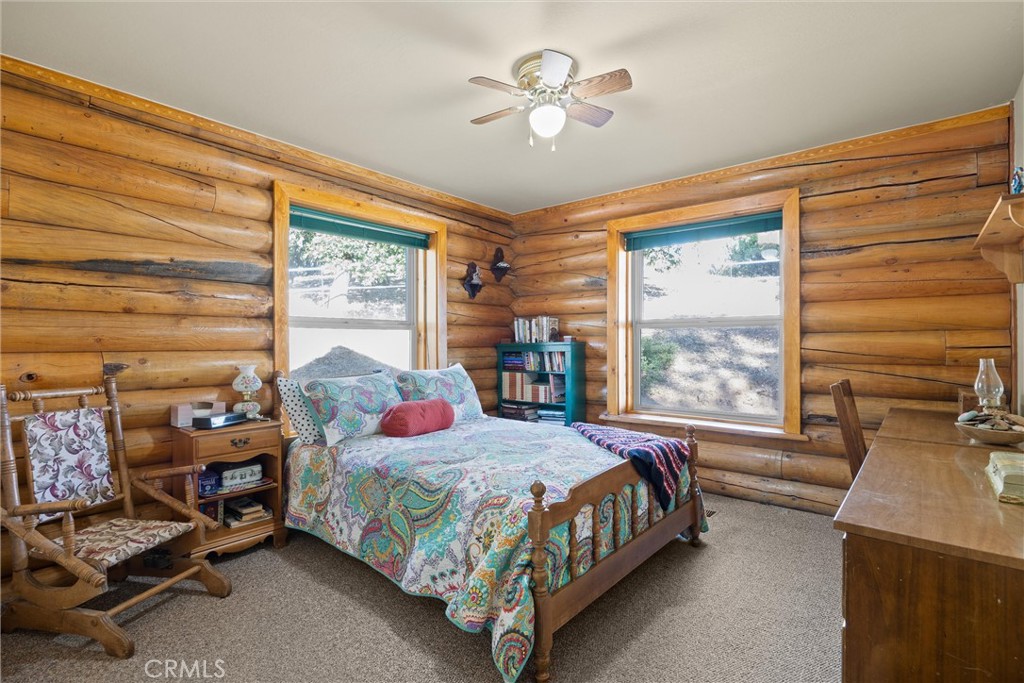 4592 Wendlis Road Forest Ranch, CA 95942 - Photo 36 of 64 a bedroom with a bed a couch and a window