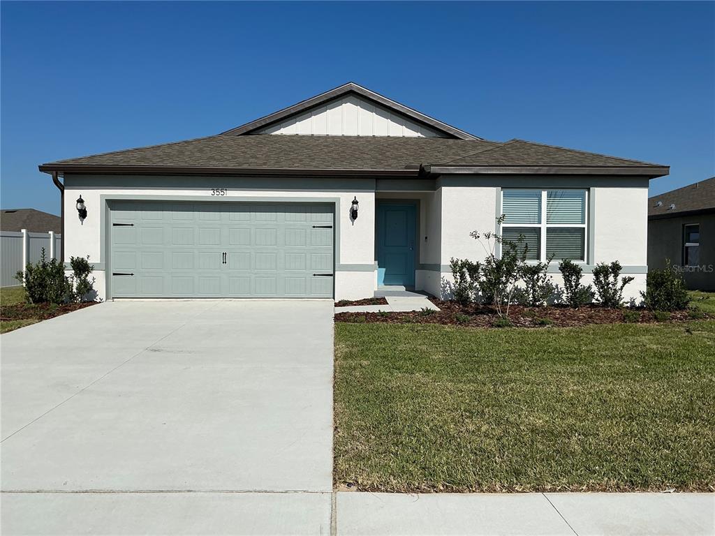 3551 Benham Rise Road Spring Hill, FL 34609 - Photo 1 of 1 a front view of a house with a garden and chairs