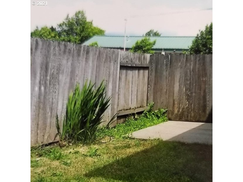 830 Janus Street Springfield, OR 97477 - Photo 11 of 11 a view of a backyard with wooden fence