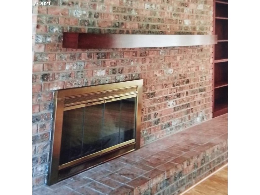 830 Janus Street Springfield, OR 97477 - Photo 6 of 11 a stone fireplace with a clock on it