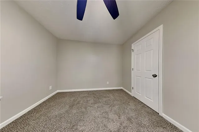 a bathroom with a granite countertop sink toilet a mirror and shower