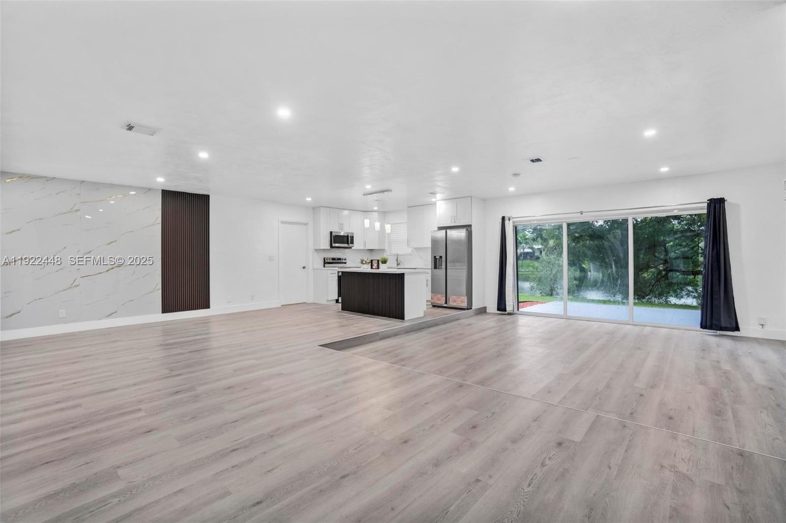 14431 Northwest 13th Road Miami, FL 33167 - Photo 11 of 39 a view of a kitchen with a sink and a large window