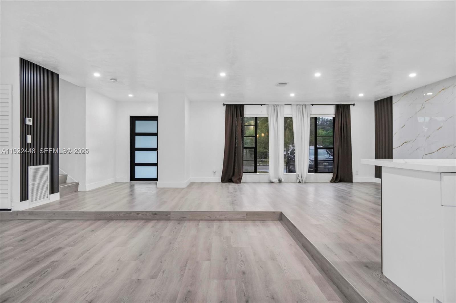 14431 Northwest 13th Road Miami, FL 33167 - Photo 12 of 39 an empty room with wooden floor and entryway
