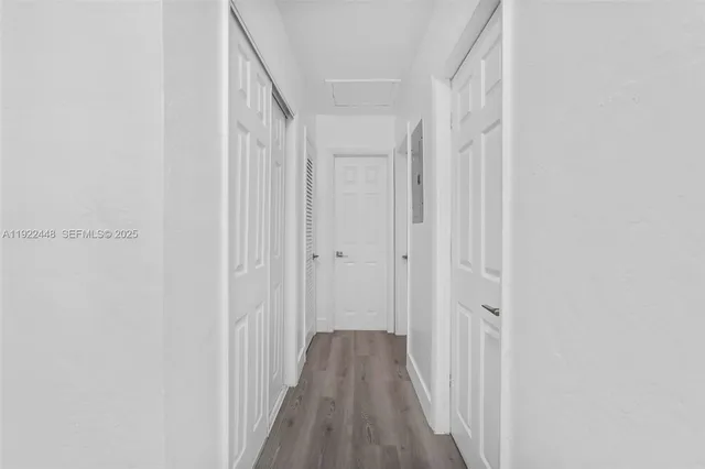 a view of a hallway with wooden floor and entryway