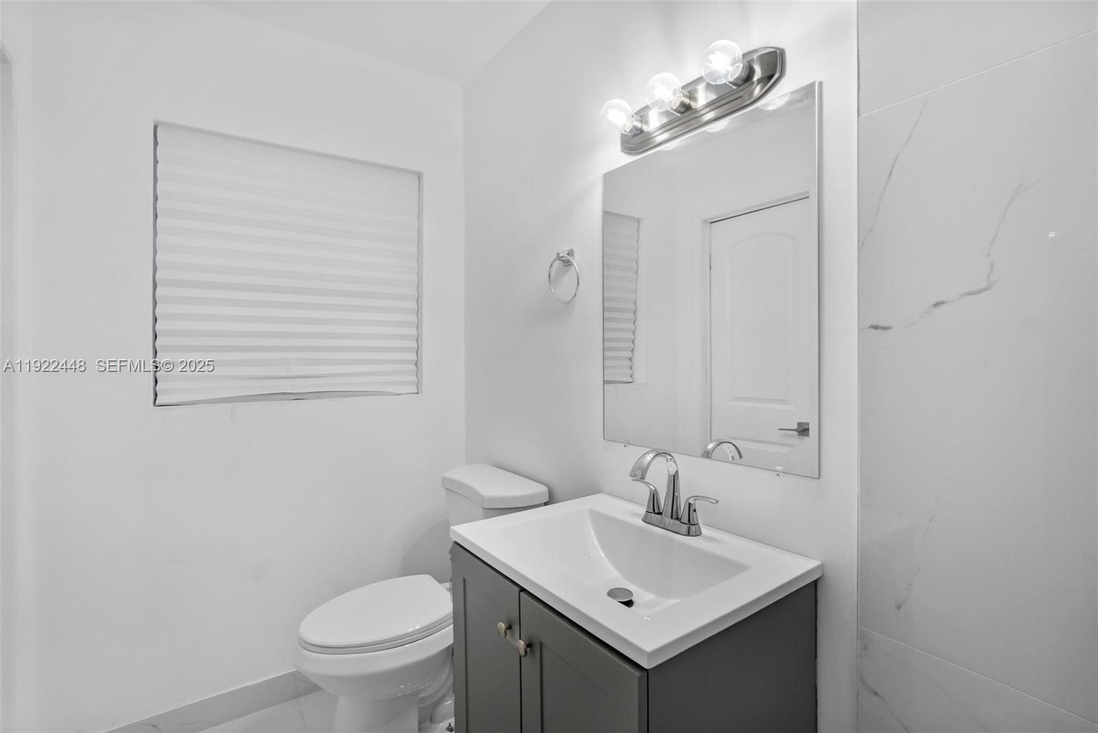 14431 Northwest 13th Road Miami, FL 33167 - Photo 22 of 39 a bathroom with a sink toilet and mirror