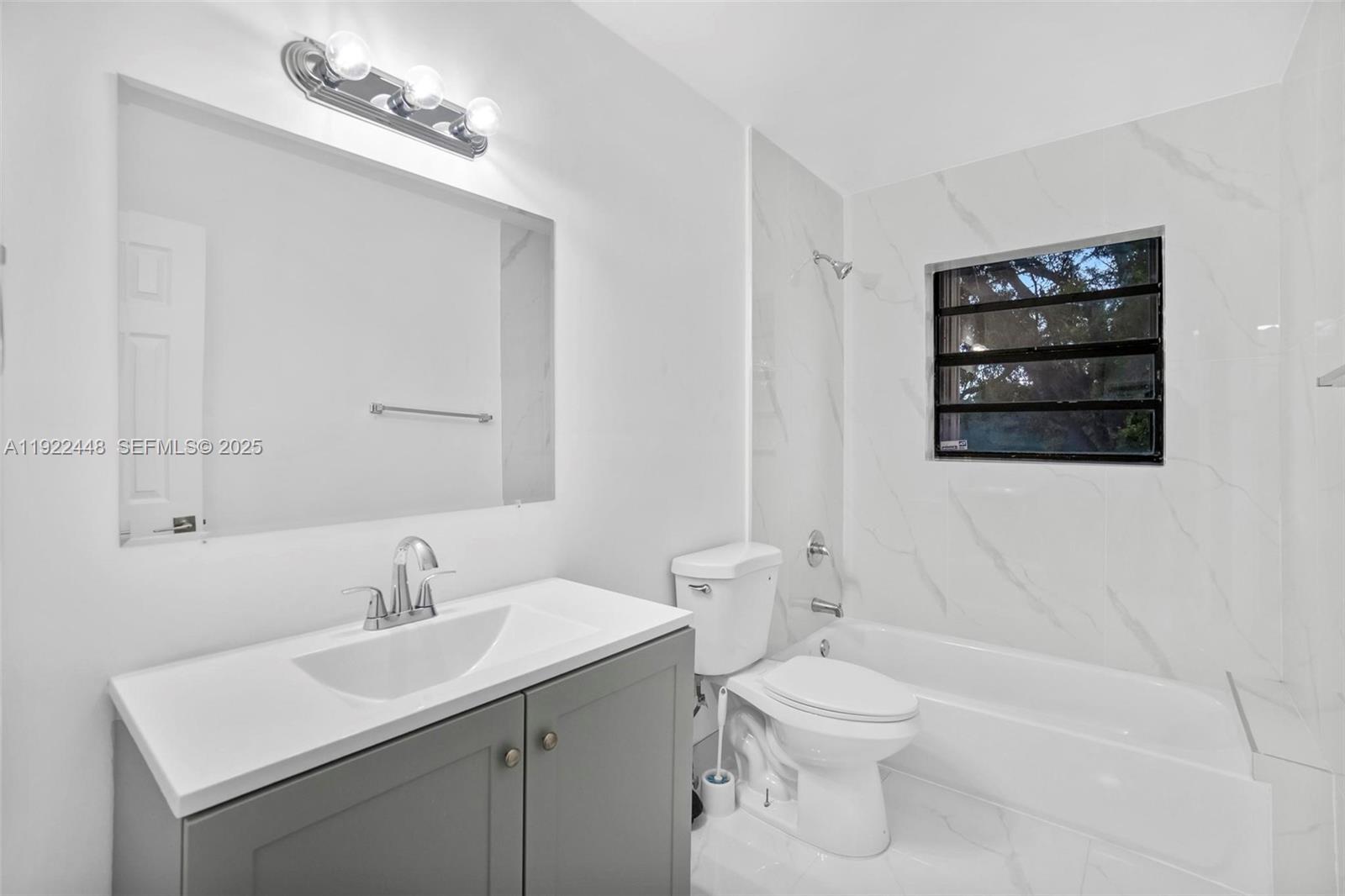 14431 Northwest 13th Road Miami, FL 33167 - Photo 25 of 39 a bathroom with a toilet a sink and mirror