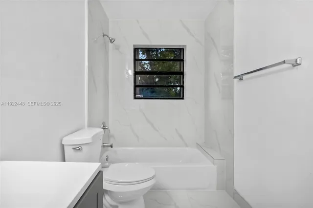 a bathroom with a toilet a sink and bathtub