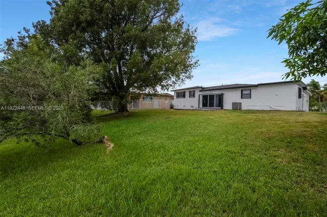 a view of a house with a yard porch and sitting area