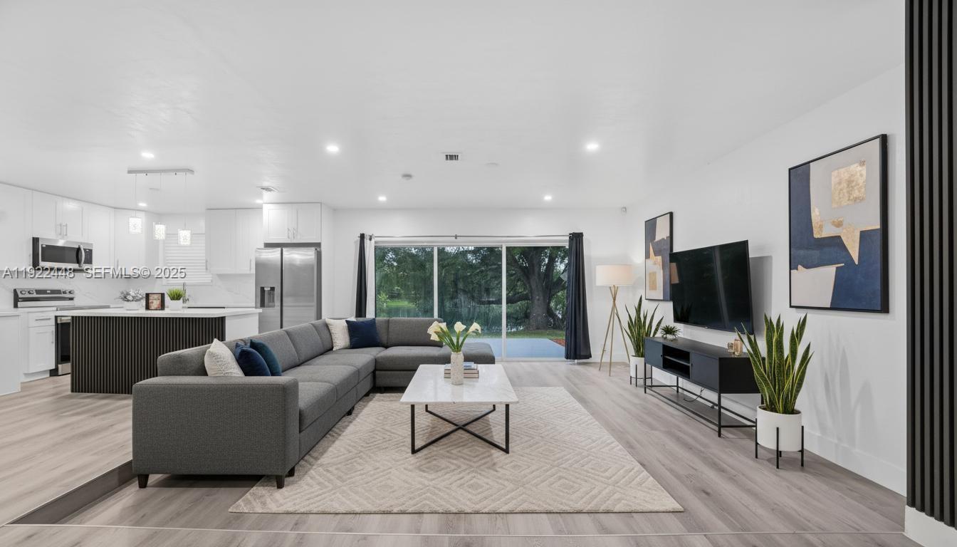 14431 Northwest 13th Road Miami, FL 33167 - Photo 3 of 39 a living room with furniture and a flat screen tv