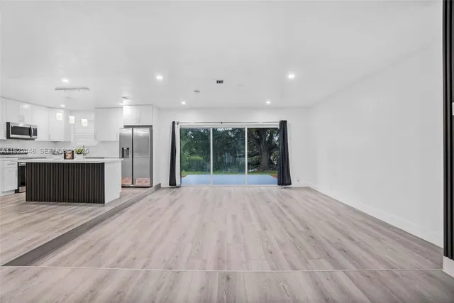 a view of kitchen with wooden floor