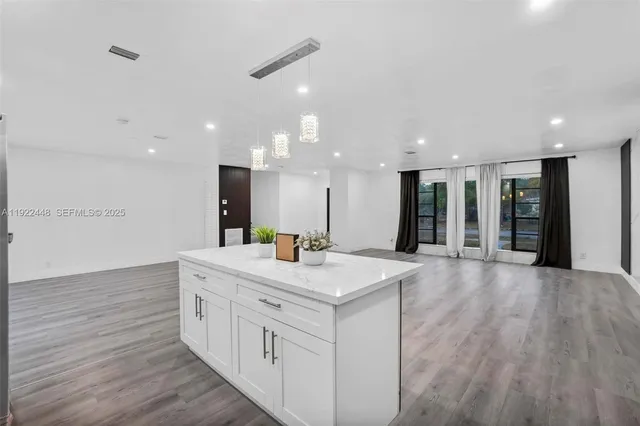 a large white kitchen with a sink and dish washer