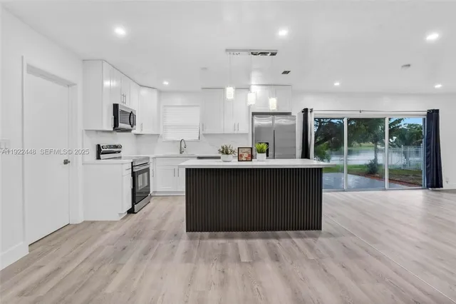 a kitchen with a cabinets and wooden floor