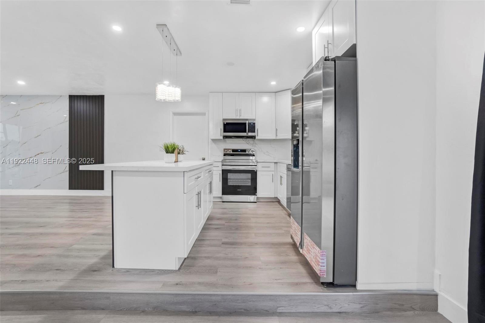 14431 Northwest 13th Road Miami, FL 33167 - Photo 7 of 39 a kitchen with stainless steel appliances a stove top oven a sink and a refrigerator