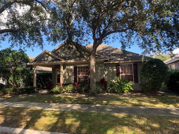a view of a house with a tree in front