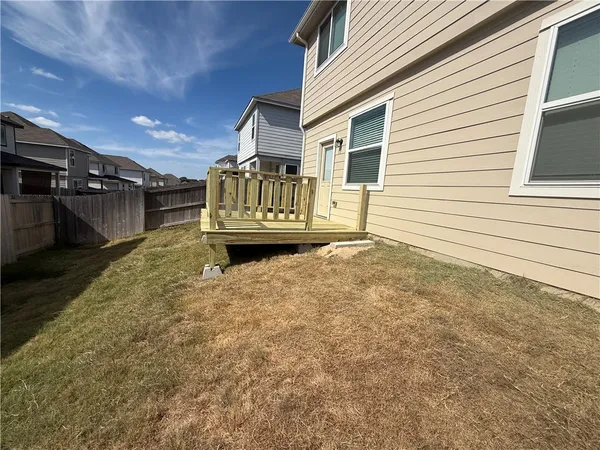 a view of balcony with wooden floor and fence