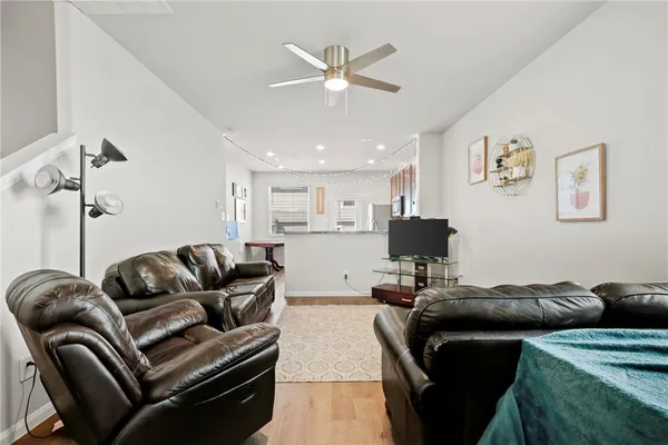 a living room with furniture and kitchen view