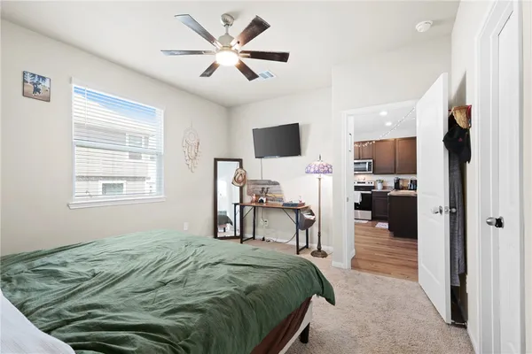a bedroom with a bed and a chandelier