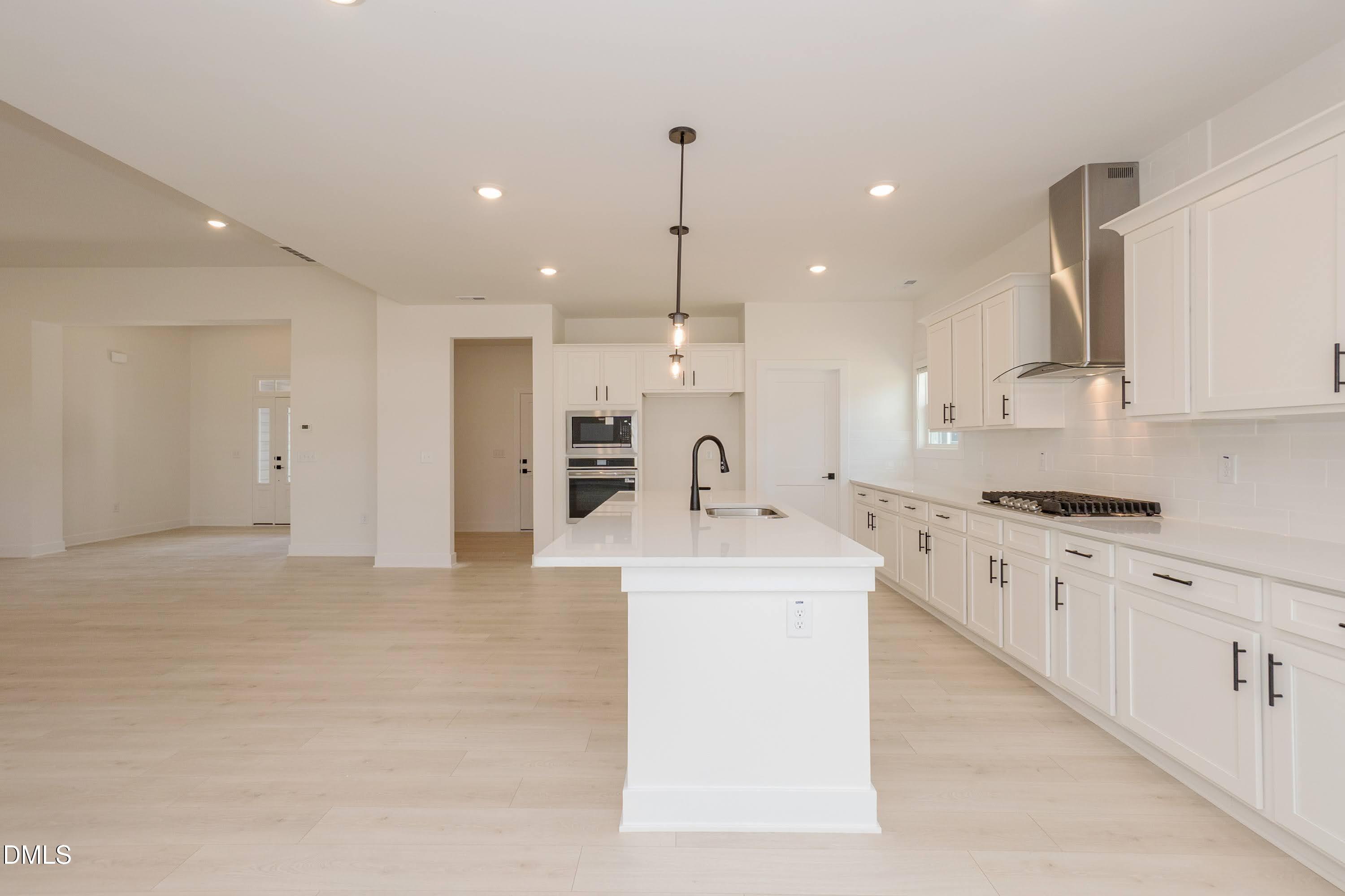 180 Galway Road Lillington, NC 27546 - Photo 13 of 41 a large kitchen with stainless steel appliances kitchen island granite countertop a sink and white cabinets